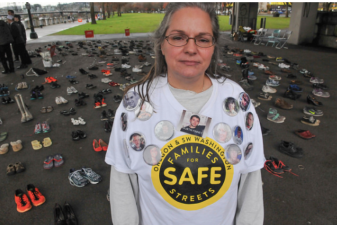 Kristi Finney, who lost her son Dustin when a truck driver hit him from behind while biking, stands before 421 pairs of shoes symbolizing each person killed in traffic in Oregon so far this year. "The average person is indifferent to this until it happens to them," she told Bike Portland.