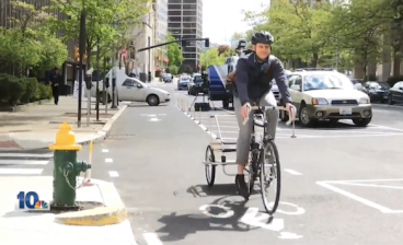A row of plungers now keeps cars out of this bike lane in downtown Providence. Photo: WJAR-TV