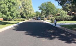 Christina Alderfer stands on her wide, suburban street with no sidewalks, where drivers have free reign. Photo: Zach Bishop