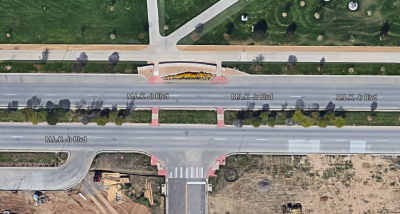The median on Martin Luther King Jr. Boulevard in Stapleton has pedestrian crossings, but it's still a fundamentally dangerous, car-oriented street. Image: Google Maps