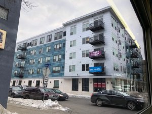 This 70-unit apartment building was built after Minneapolis relaxed its parking requirements. It still has parking, but only surface spots, not the costly underground garage that the old rules would have required. Photo:  Nick Magrino