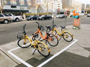 So close, Seattle! The city is reserving space for dockless bike-share parking on the sidewalk, not the curb lane. Photo: Seattle DOT