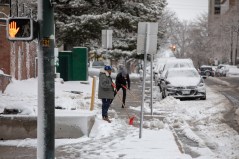 Photo Two men shovel snow