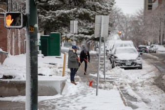 Photo Two men shovel snow