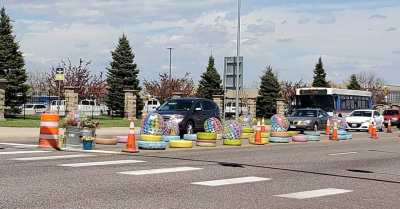 A pop-up traffic-calming event placed flowers, beach balls, pastel-painted tires and bales of hay on a stretch of Federal Boulevard on Saturday afternoon. Photo: WalkDenver