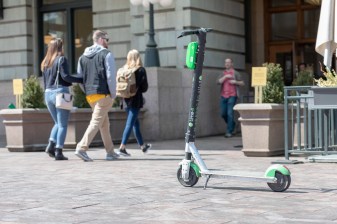 A Lime scooter parked in front of the main entrance to Union Station.