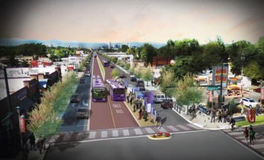 A rendering shows how East Colfax Avenue would change at North Krameria Street with the introduction of center-running dedicated bus lanes in a bus rapid transit system that the city has been planning. Image: City of Denver