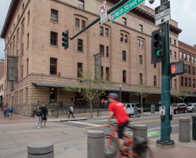 Pedestrians and a cyclist disregard a red light to cross Wynkoop St. at 16th St.