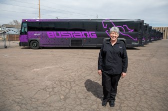 Driver Krista Dalton poses for a photo at the Bustang yard near Golden. After the photo, she started a pre-trip inspection of the motor coach she would drive from Denver to Colorado Springs.