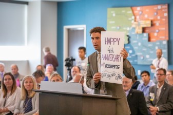 Danny Katz of CoPRIG presents a giant card celebrating the success of Bustang to state transportation commissioners Thursday. Photo: Andy Bosselman