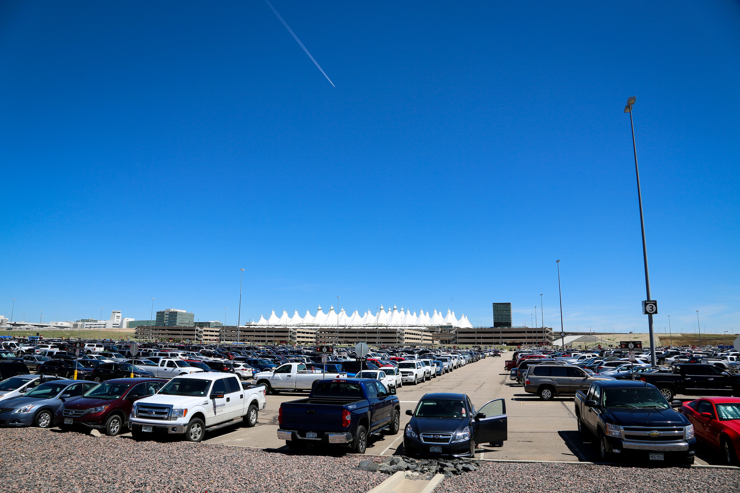 A sea of car storage in extends until it reaches four massive parking structures. Image: Denver International Airport