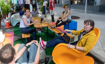Maggie Thompson, a legislative aide to Denver City Councilperson Jolon Clark, meets with other aides at a Park(ing) space on outside of the Wellington Webb Municipal Building. Photo: Andy Bosselman