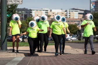 A crew of human eyeballs crosses Larimer St. at Speer Blvd. as a part of a campaign to raise awareness of pedestrian safety. Photo: Any Bosselman
