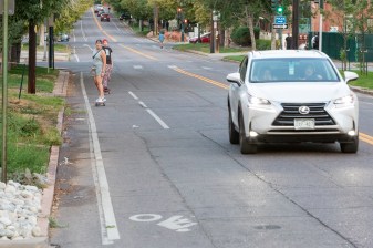Two skateboarders use what remains of the bike lane on E. 16th Ave. near Pearl St. on Sept. 26. Photo: Andy Bosselman