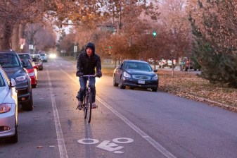A bicyclist rides on S. Marion St. Parkway Nov. 7. The city presented a protected bike lane it will install on the left side of the street. Photo: Andy Bosselman