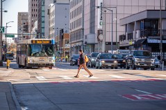 A person walks downtown. Photo credit: www.LisaMiaStudios.com
