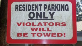 Photo sign with text resident parking only violators will be towed!