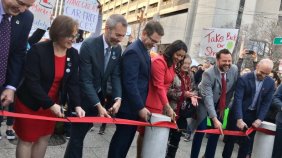 Photo people cut a ribbon on car-free Market Street in San Francisco