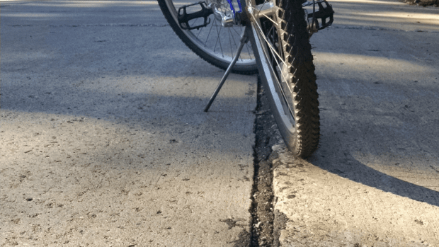 Photo bike wheels and seam in road pavement