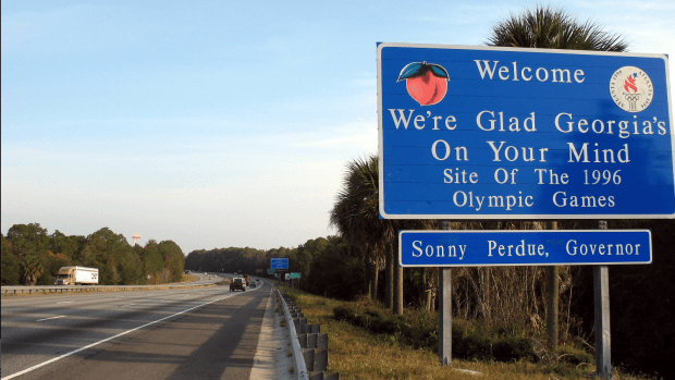 Photo of Welcome to Georgia road sign next to highway