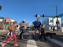 image caption: Kate Gotter hurries her children through the crosswalk at Pearl and Alameda.