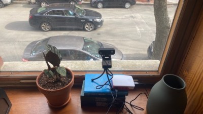 Adam Balsam's speed cam in a residence window overlooking a street with cars