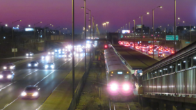 A train and highway at night