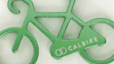Green plastic bike with text Cal Bike