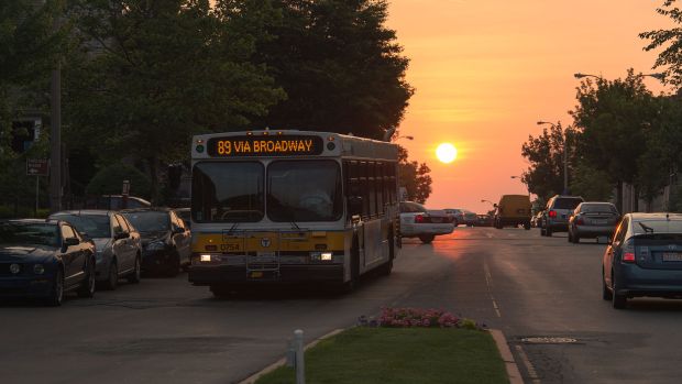 Bus on road at sunrise