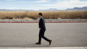 Pete Buttigieg walking on asphalt