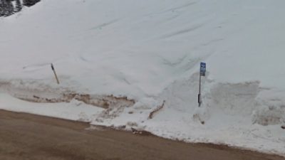 Snow pile hiding a bus stop in Alta, Utah