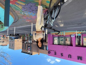 Ann Nguyen holding INC award on Santa Fe Drive in front of Museo de las Americas